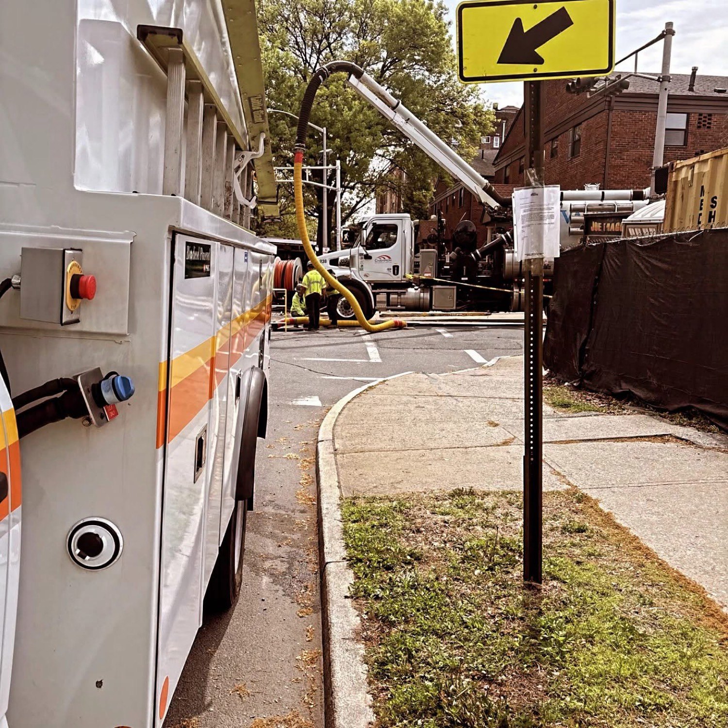 Utility truck and crew working a city intersection