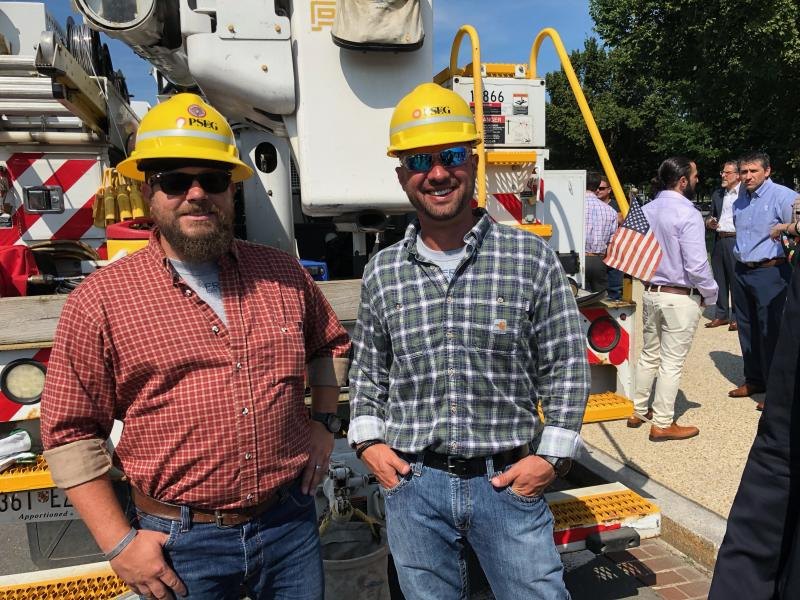 Members in hard hats walking a substation yard